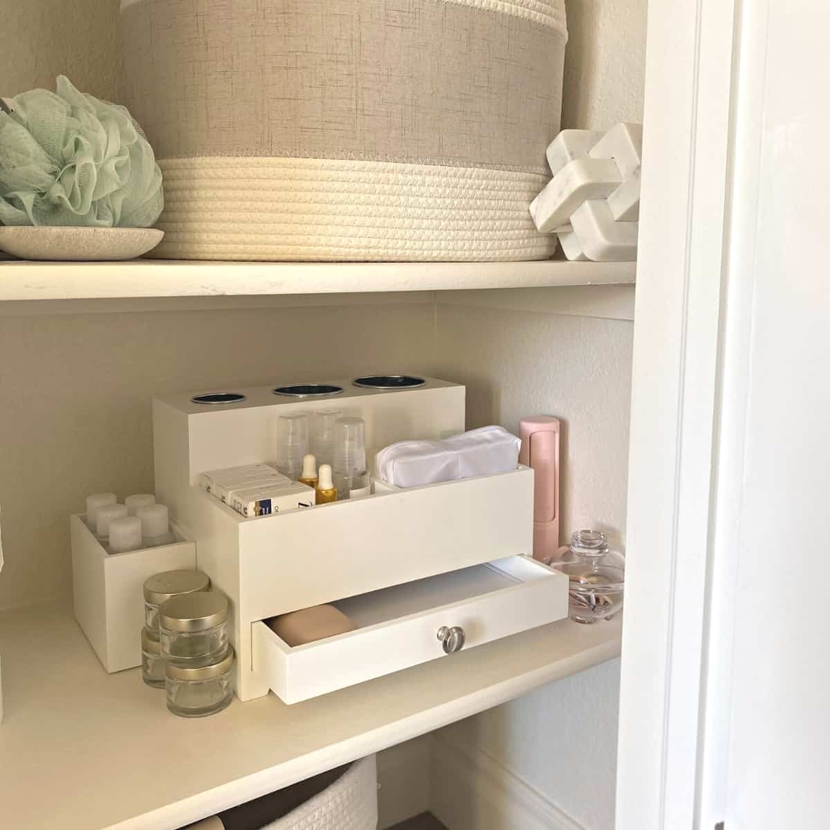 White wood hair tools and toiletries organizer in a closet