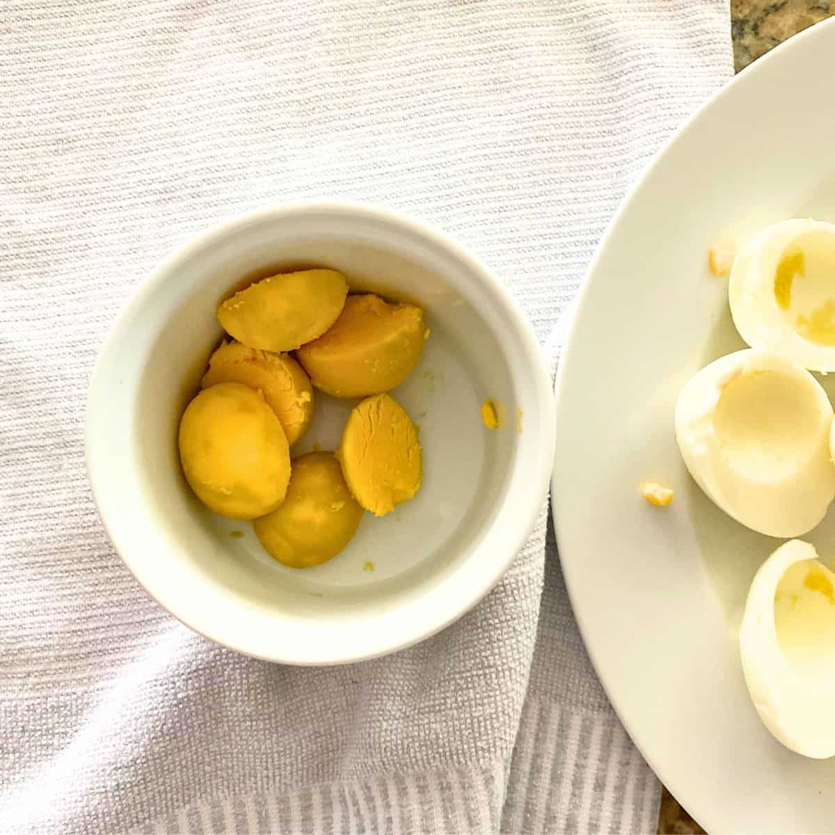 Hard boiled egg yolks in a white ramekin