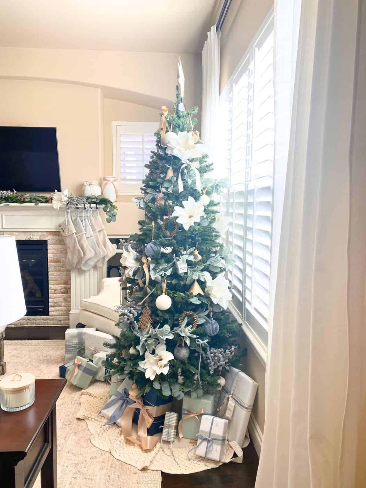 christmas tree decorated in blue, white, and wood colors