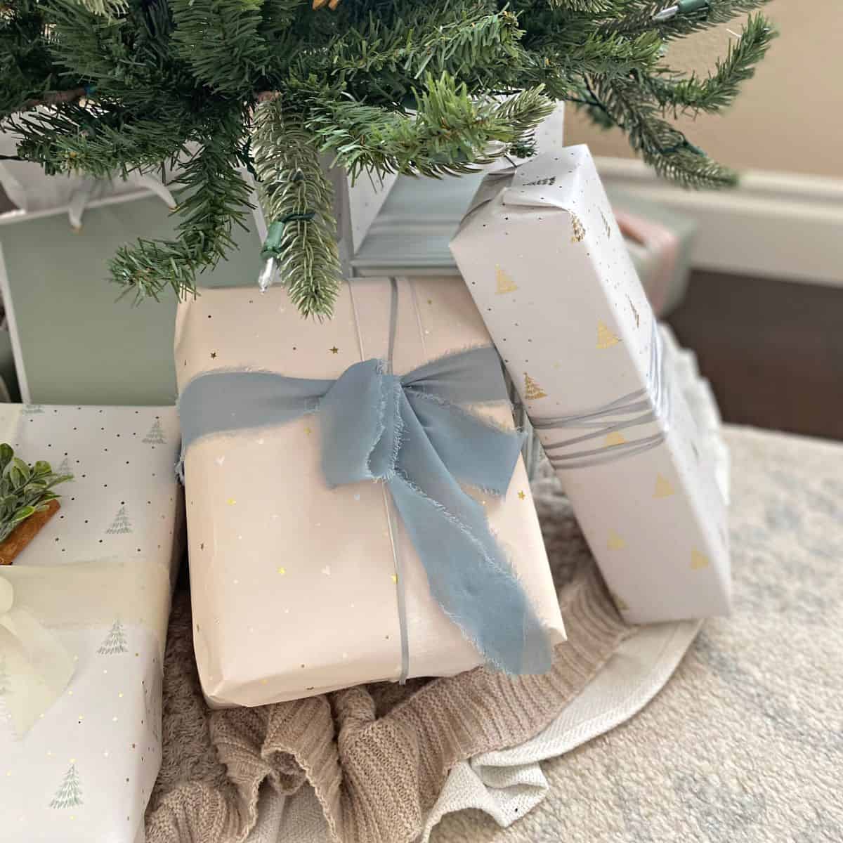 presents wrapped in pastel paper under a tree