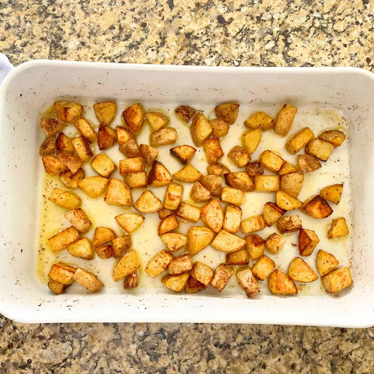 Baked seasoned home fries in a Pillivuyt porcelain rectangular roaster pan