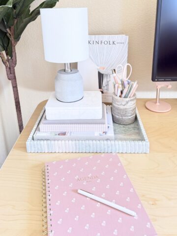desk accessories in tray on desk