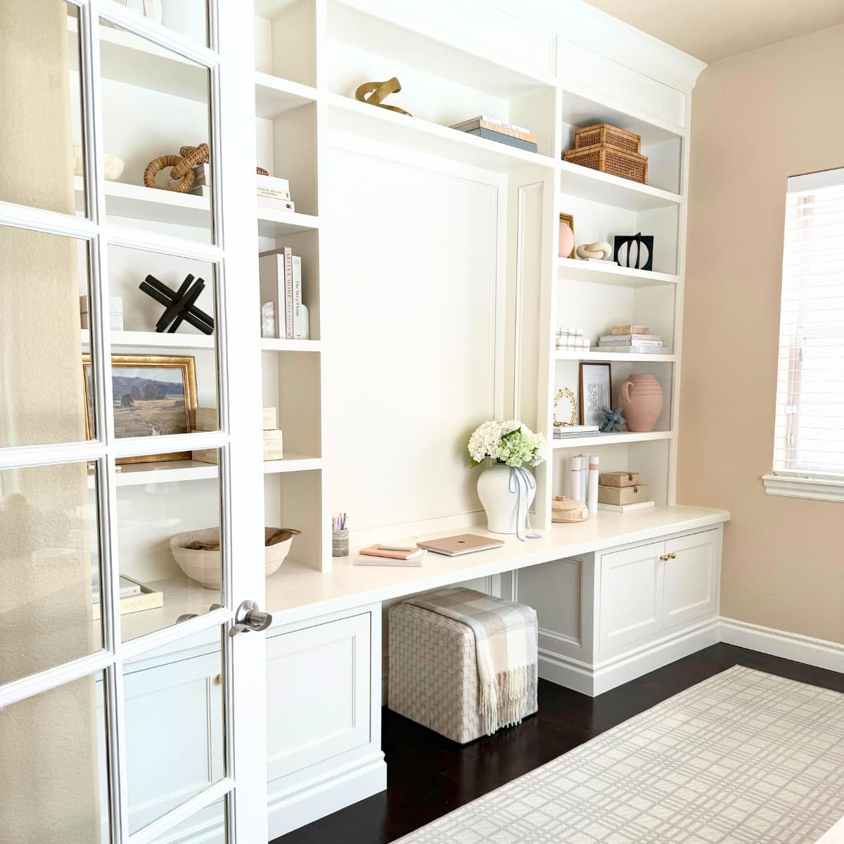 home office built-in desk painted white with ottoman