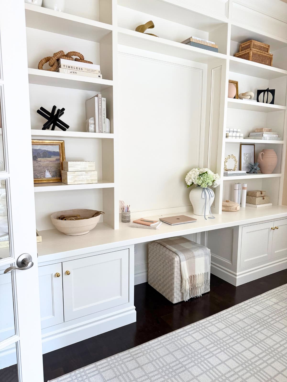 white built-in desk flanked by shelves