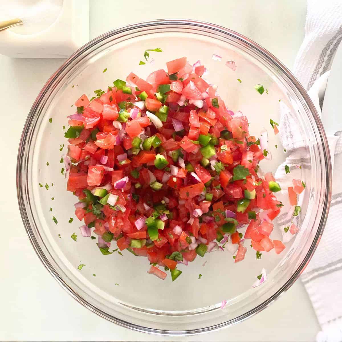 homemade pico de gallo in glass mixing bowl