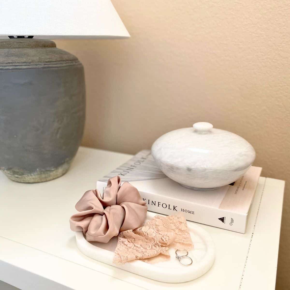 marble tray and lidded bowl on a bedside table