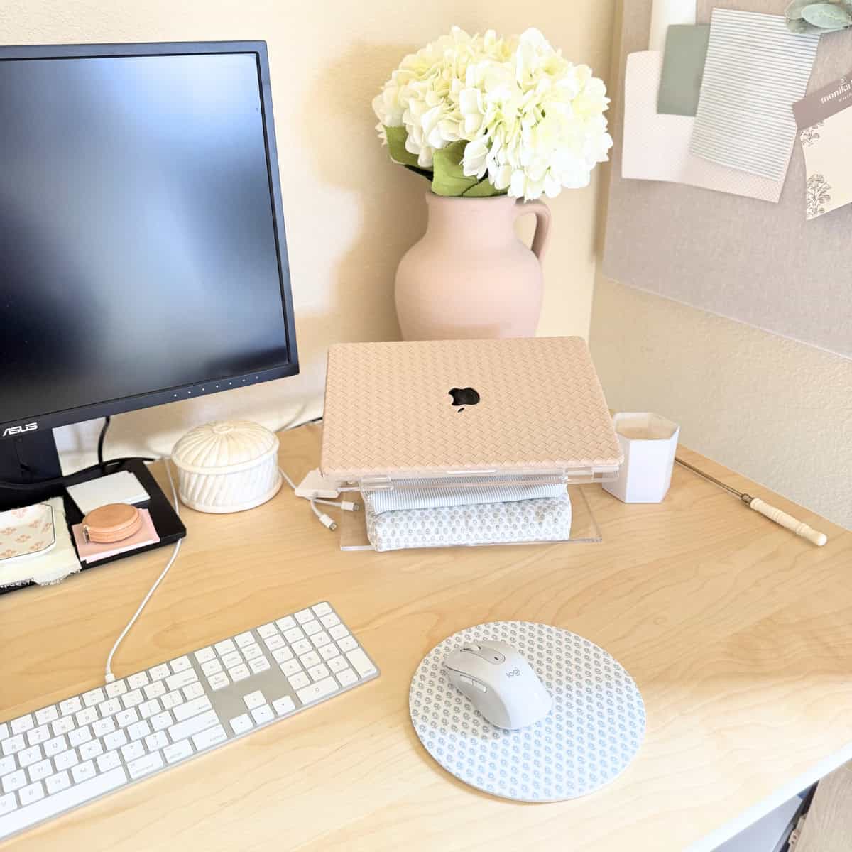 laptop on acrylic stand atop desk