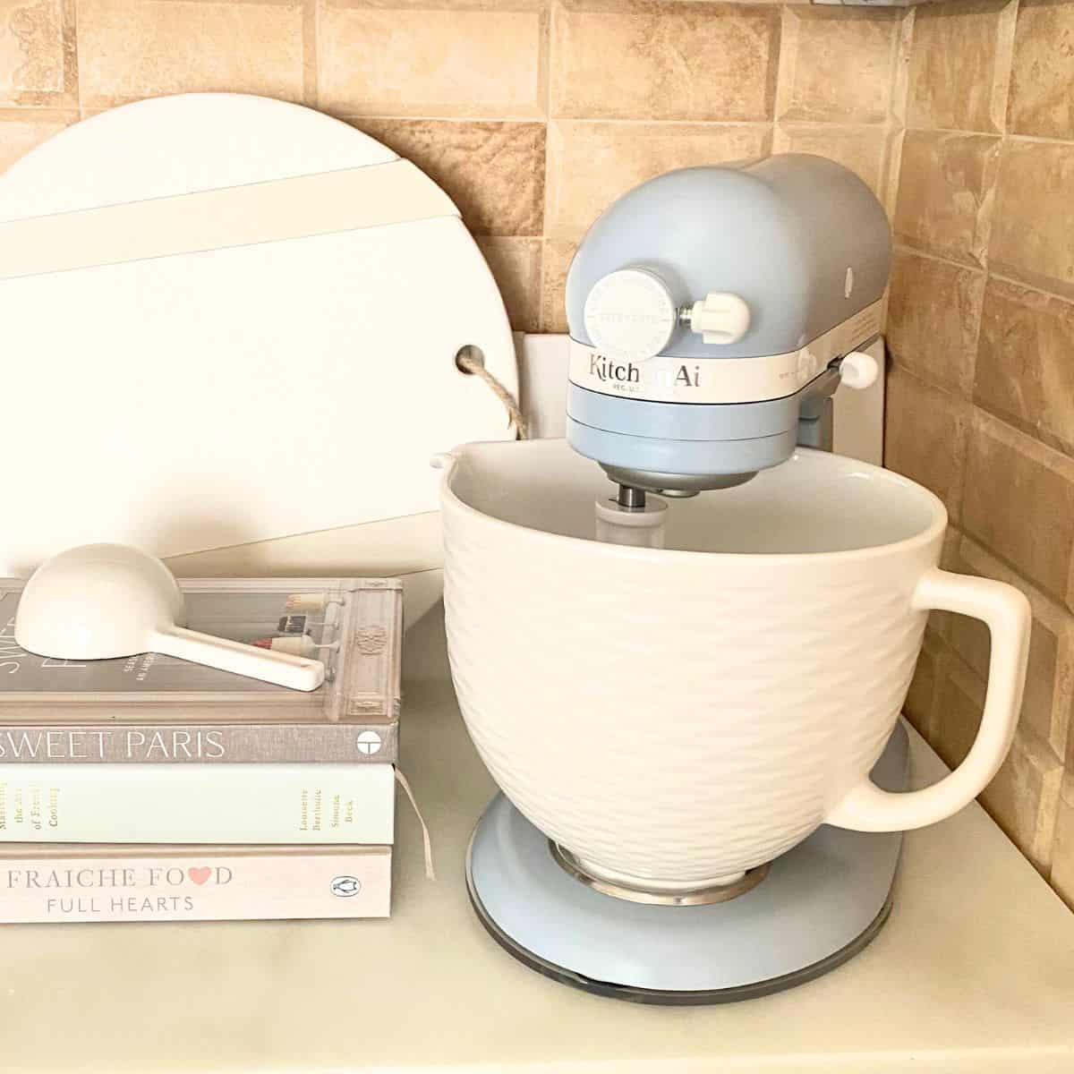 blue stand mixer with cookbooks