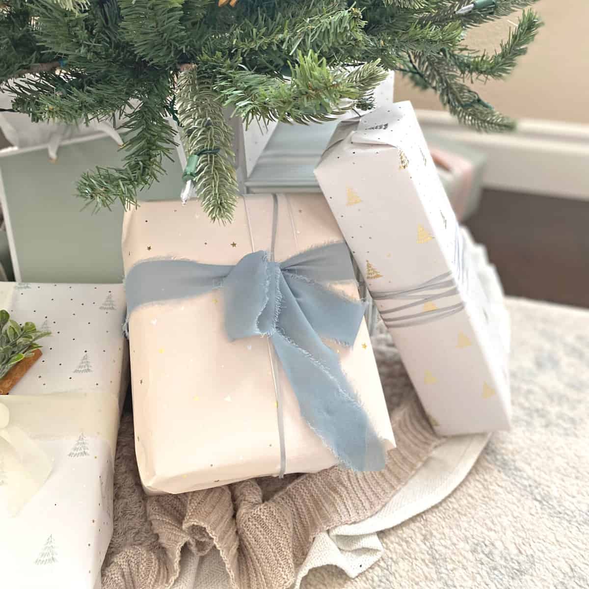 Christmas presents under a tree in neutral wrapping paper