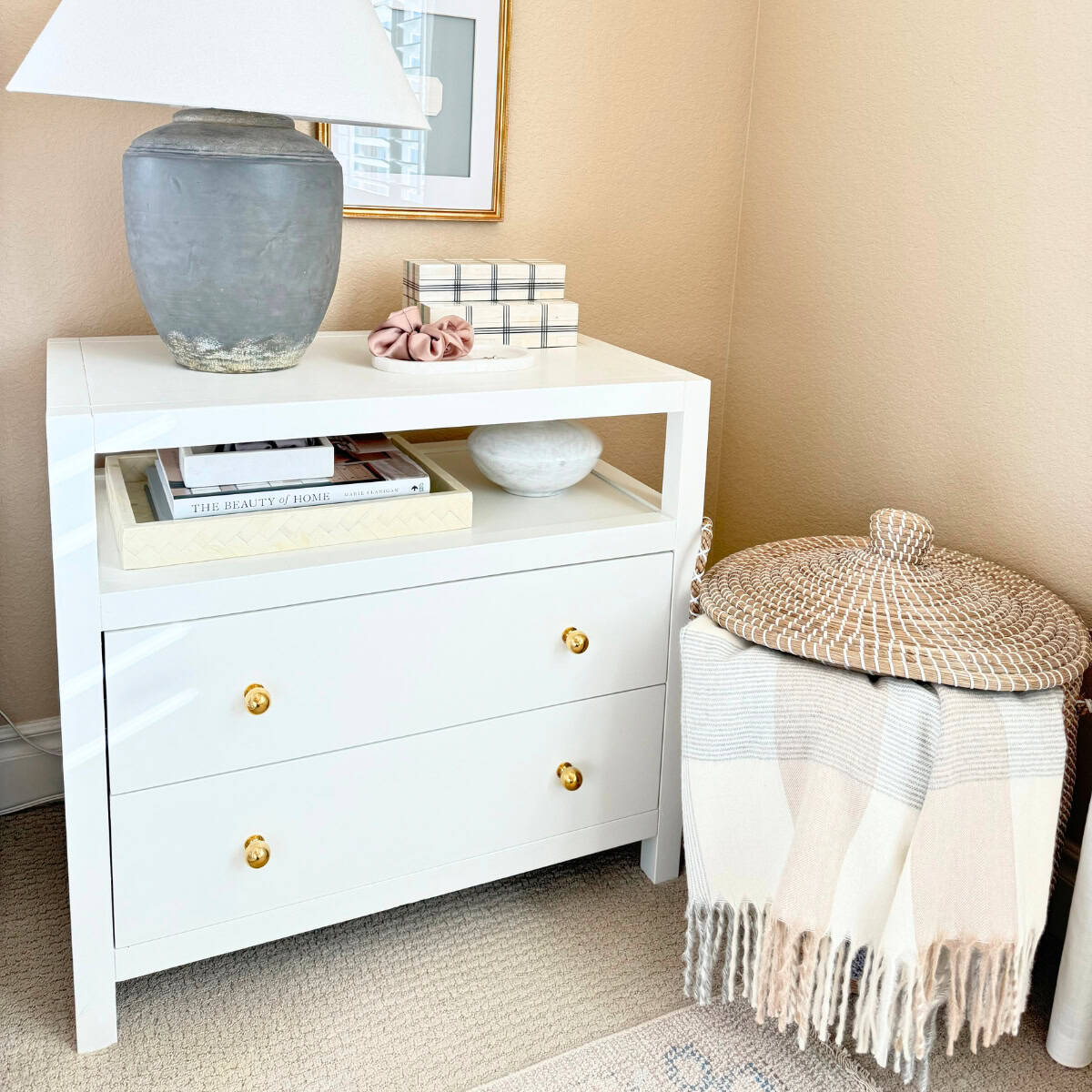 white nightstand with brass hardware styled