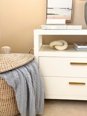 tall basket beside a white nightstand