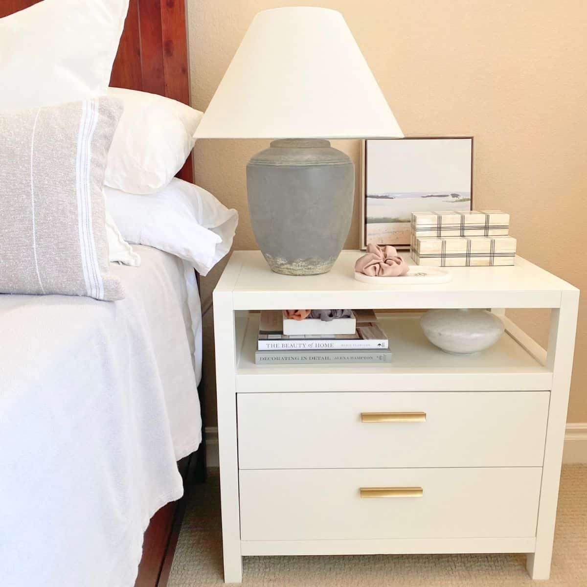 styled white nightstand with shelf and two drawers