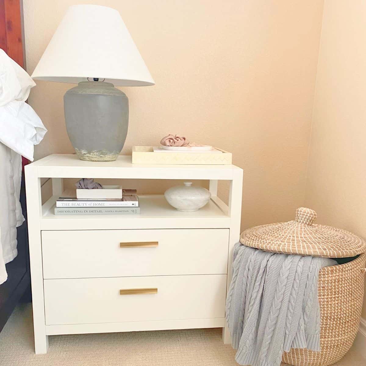 styled white nightstand with shelf and two drawers