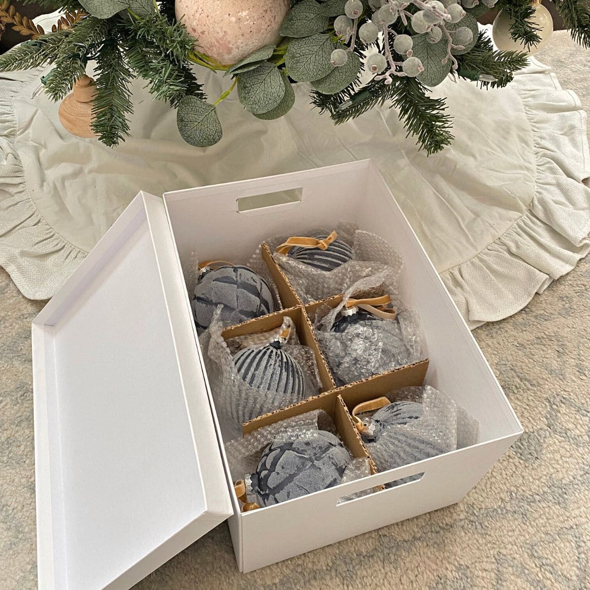 round blue ornaments in a white storage box with dividers