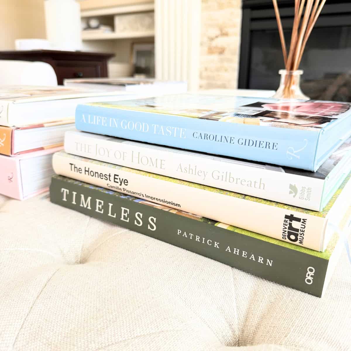 stack of books on ottoman