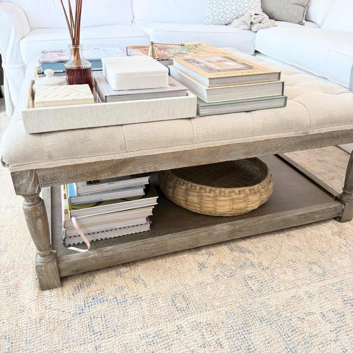 ottoman with stacks of books and decor