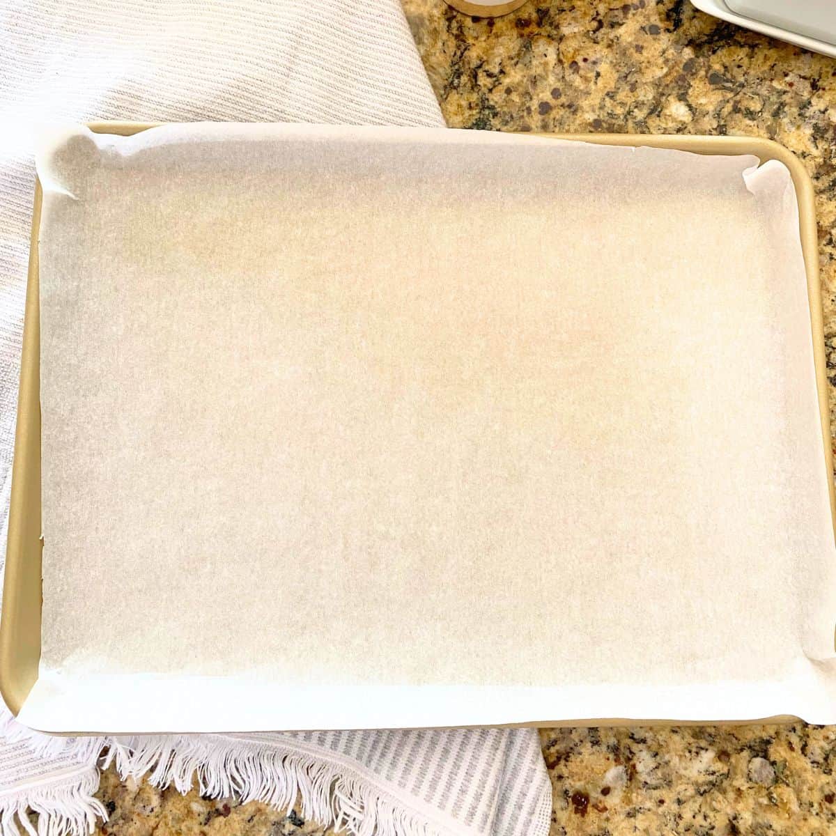 Parchment paper lined gold baking sheet pan