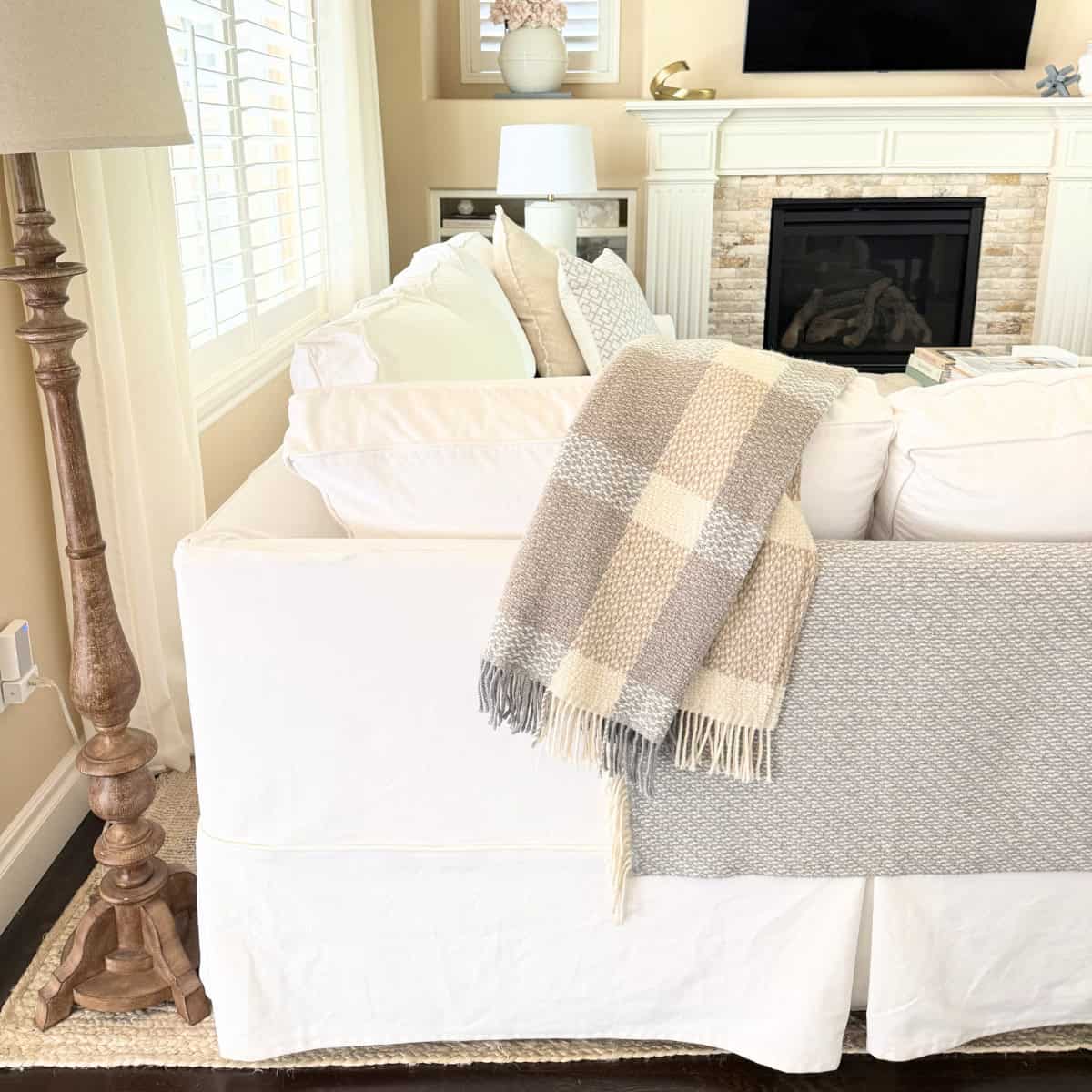 back of white slipcovered sofa in living room
