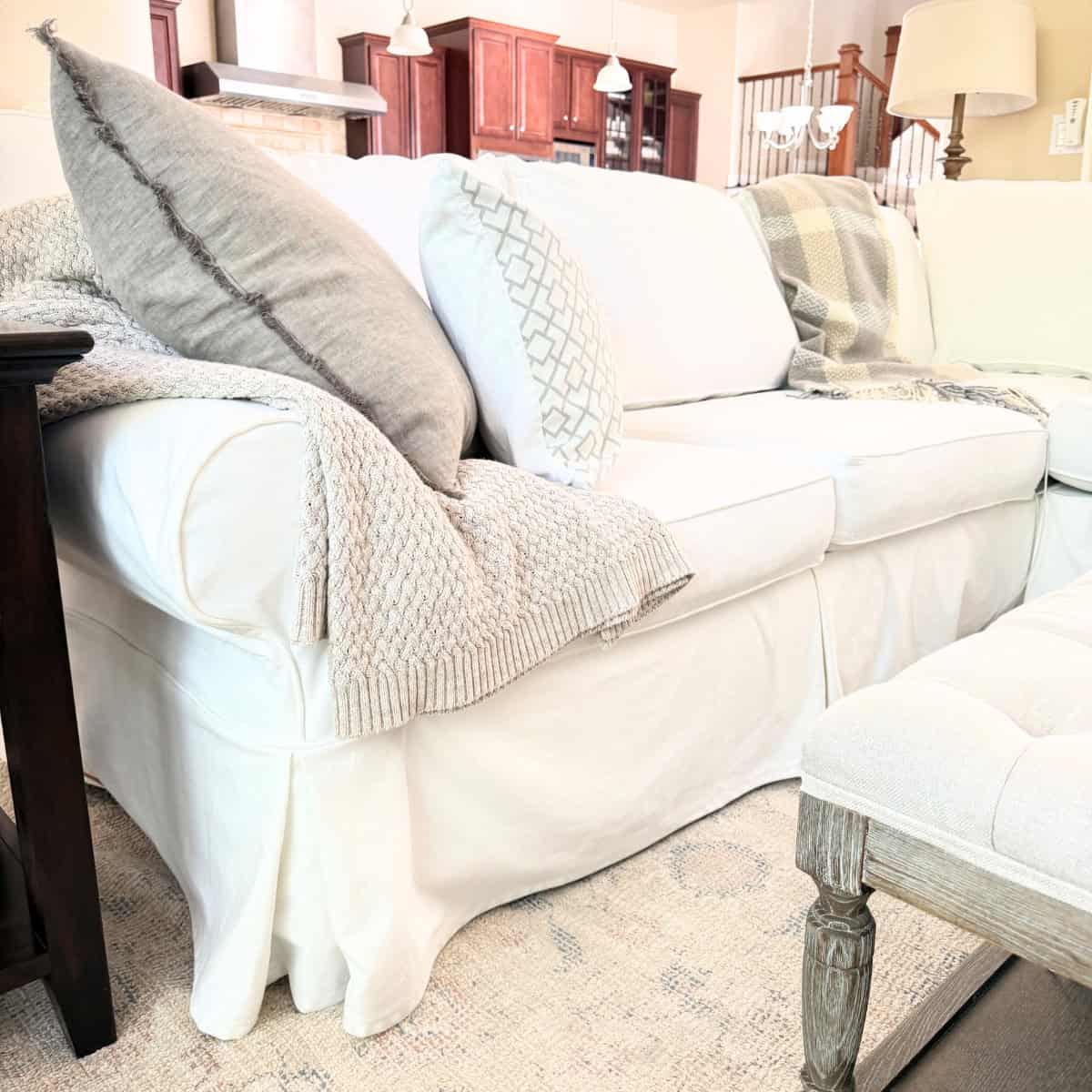 white slipcovered sofa pleated bottom