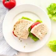pesto and cheese sandwich topped with lettuce and tomato