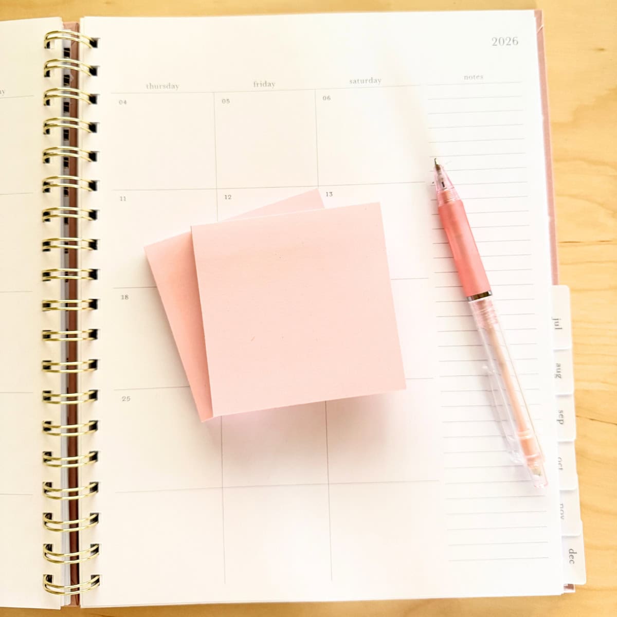 pink sticky notes with pencil