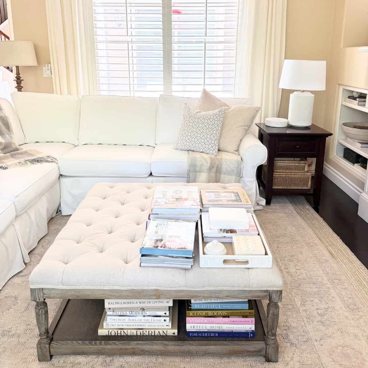 linen tufted ottoman with white sofa in living room