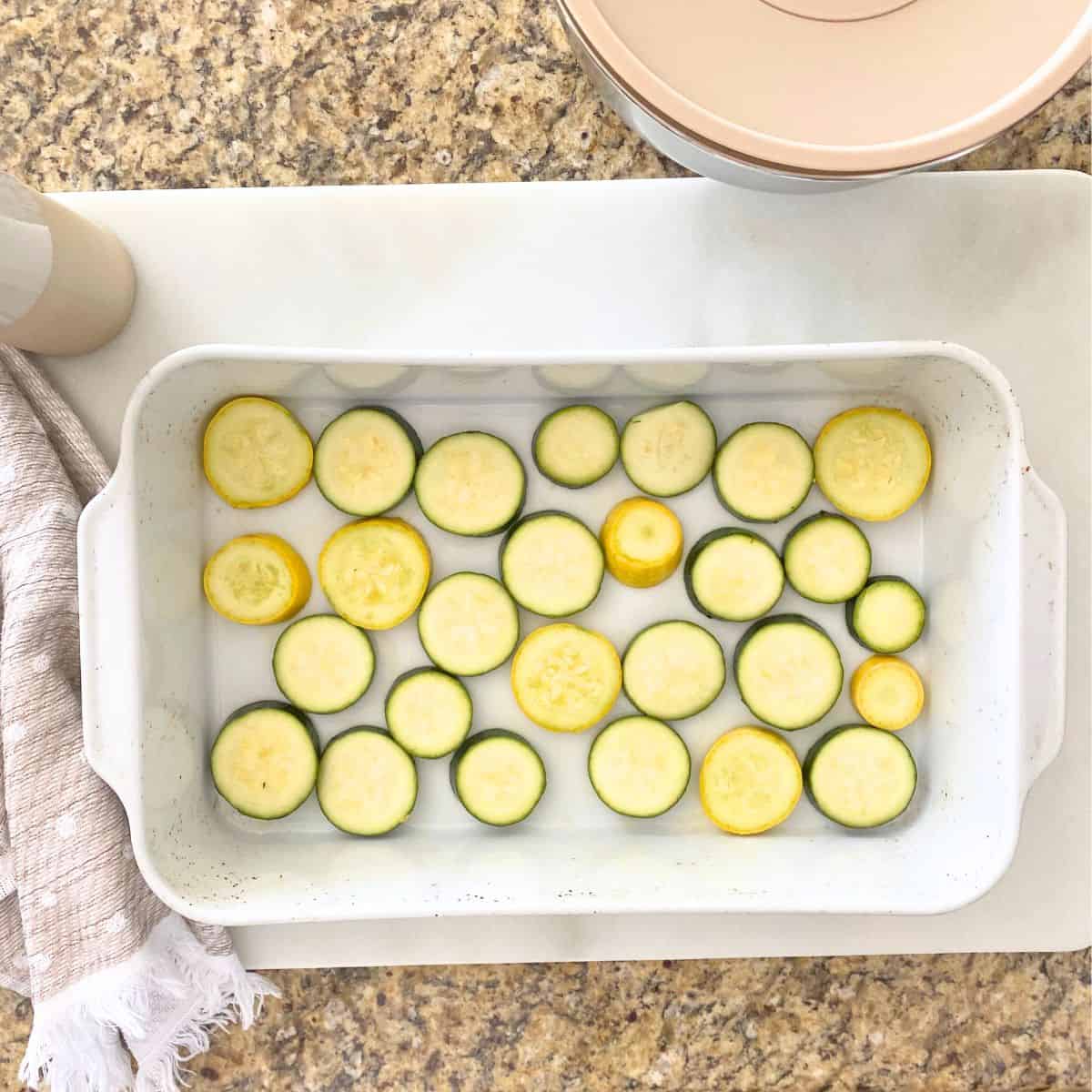 uncooked sliced vegetables in porcelain roasting pan