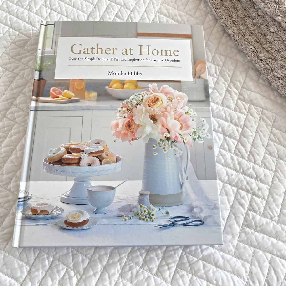 Gather at Home book by Monika Hibbs sits on top of a white herringbone cotton bedspread.