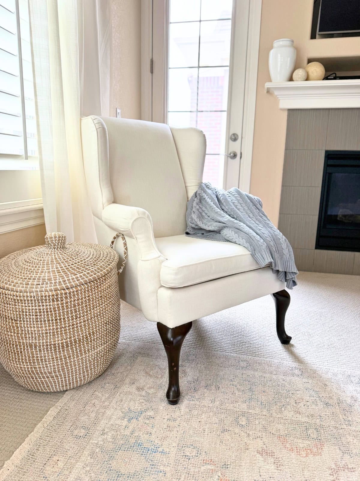 ivory basketweave wingback chair in a bedroom