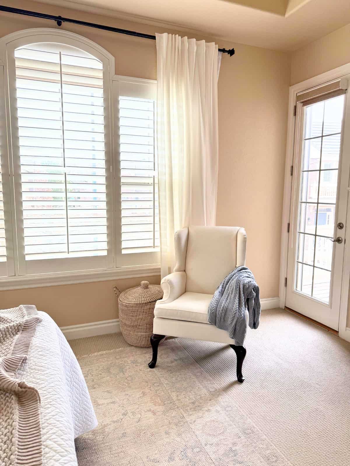 ivory basketweave wingback chair in a bedroom