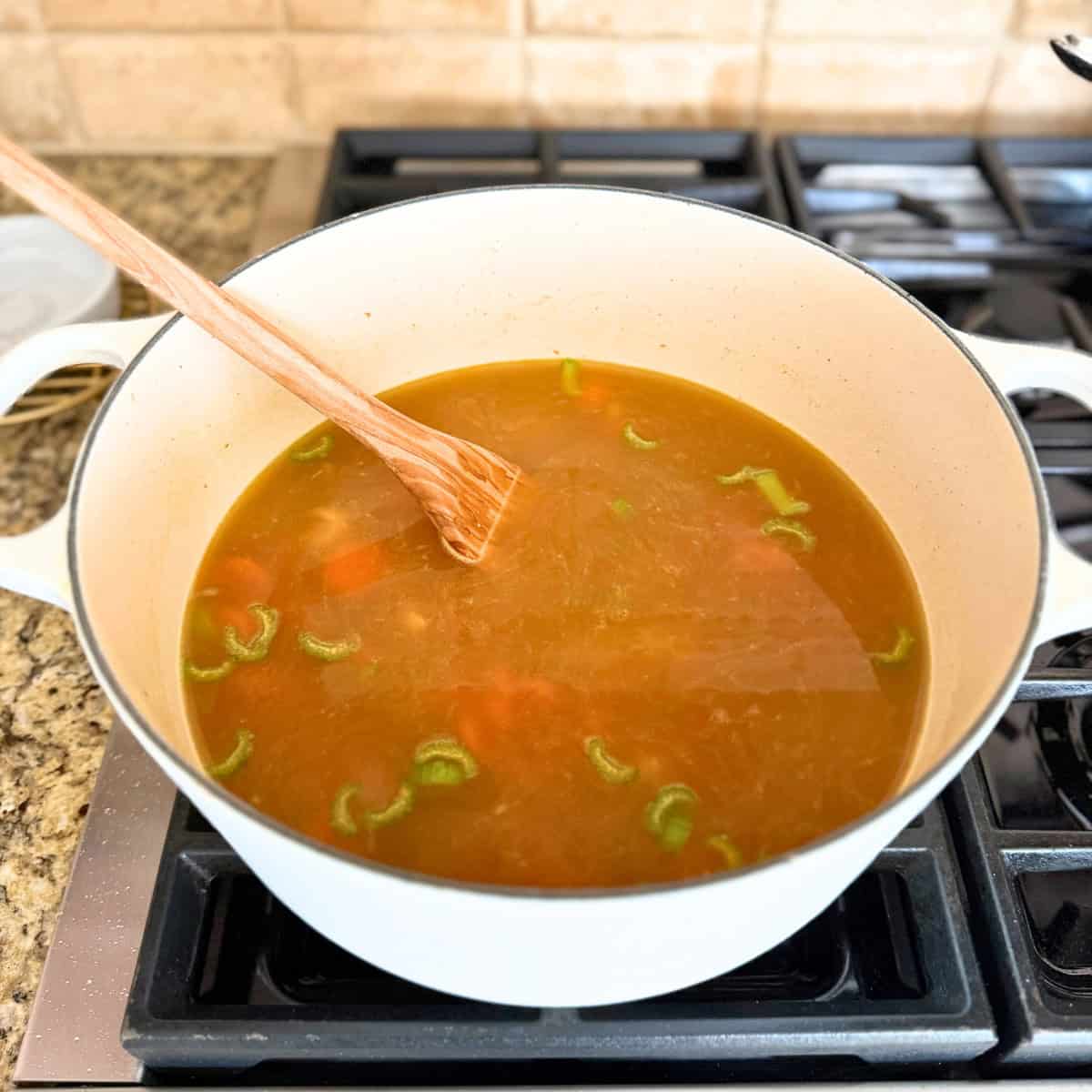 broth added to pot of chicken noodle soup
