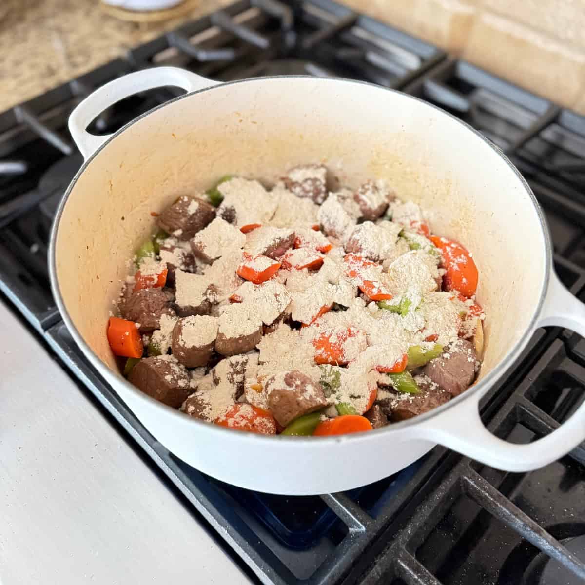 flour over cooked chuck roast and vegetables