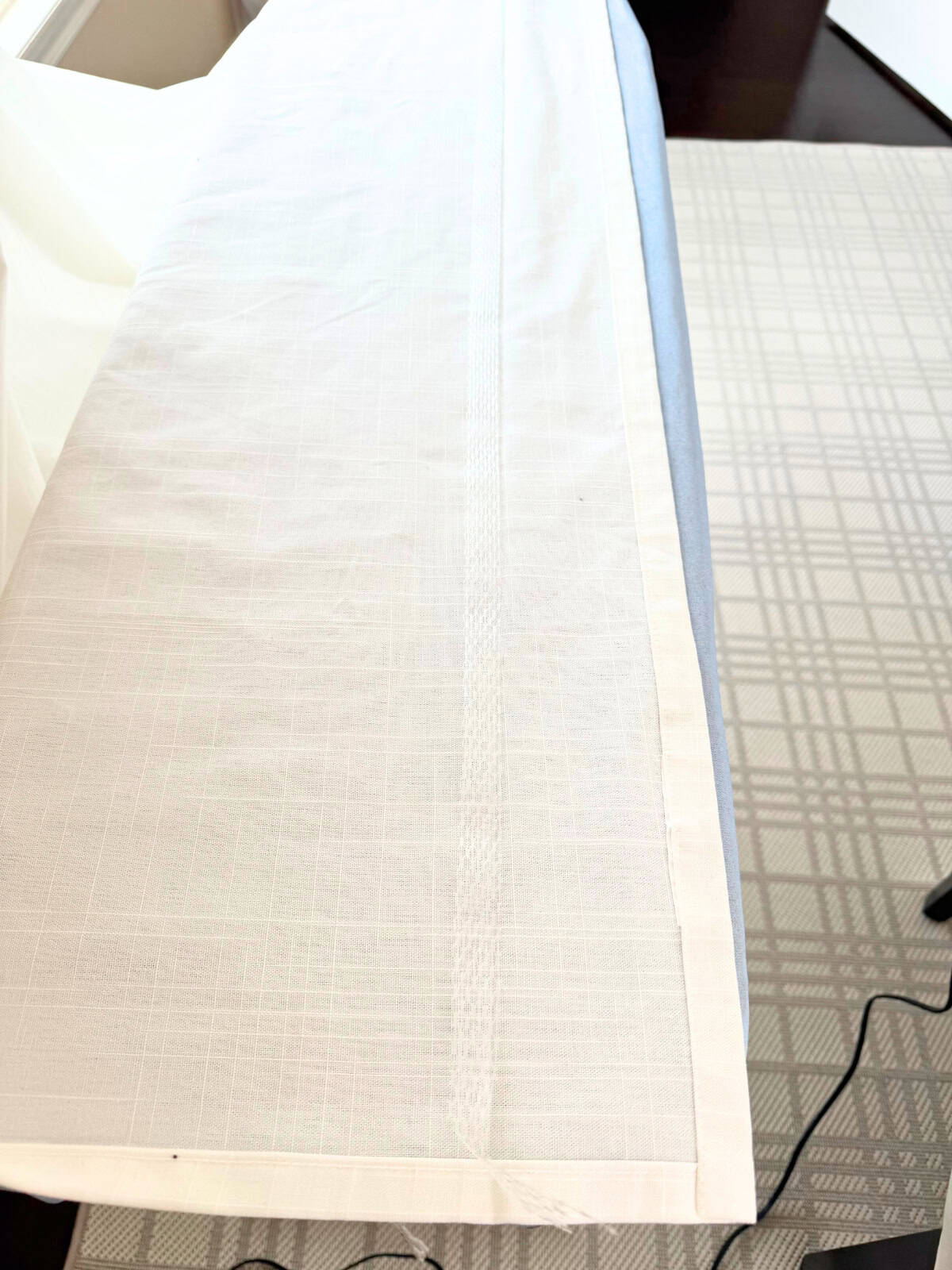 curtain with iron-on hem tape in place