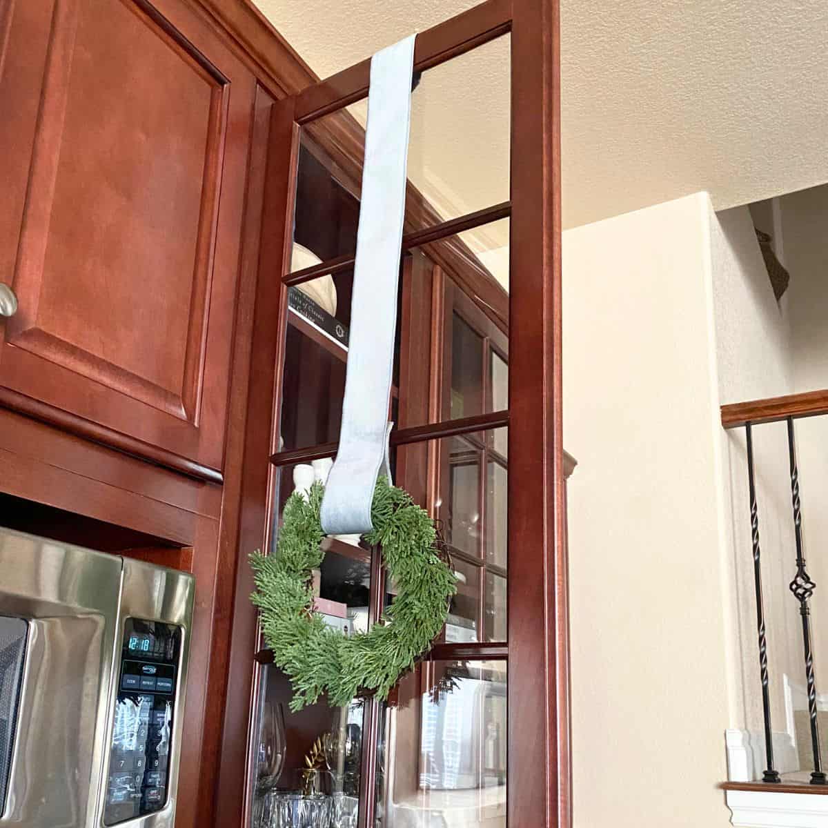 process to hang wreath on cabinet with ribbon