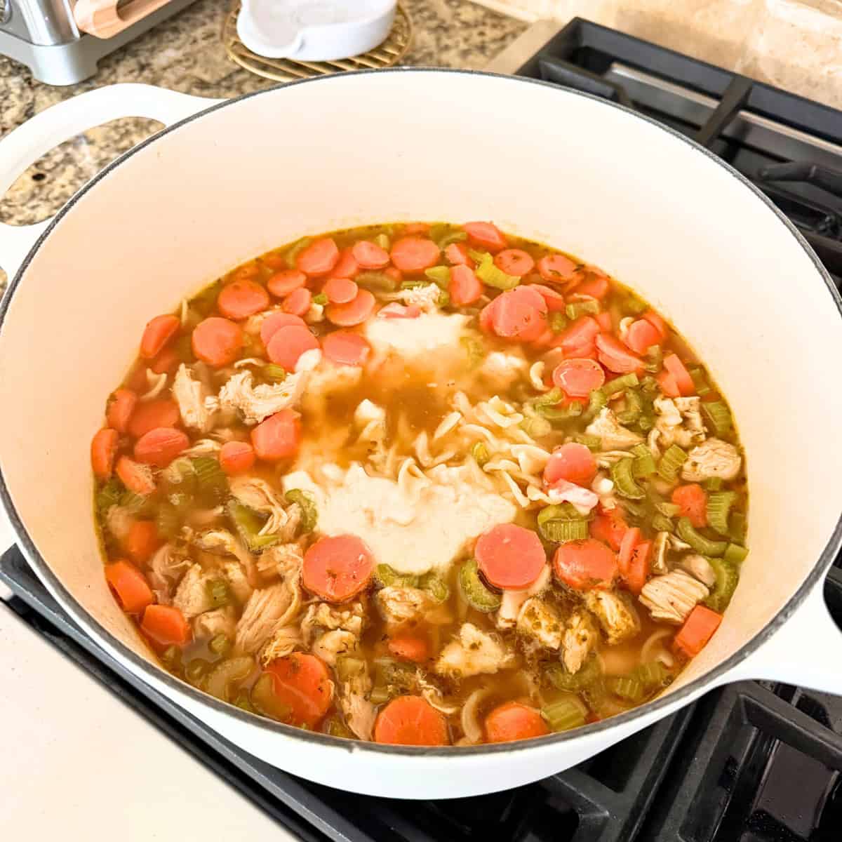 slurry added to pot of chicken noodle soup