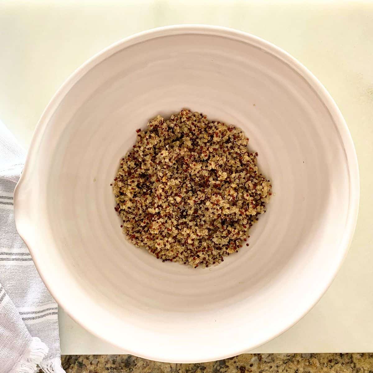 Cooked quinoa in a hand thrown mixing bowl
