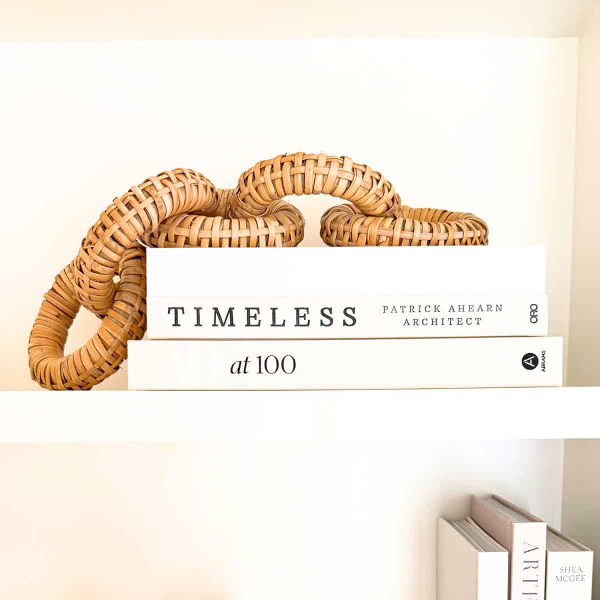 rattan links draped over stack of neutral books