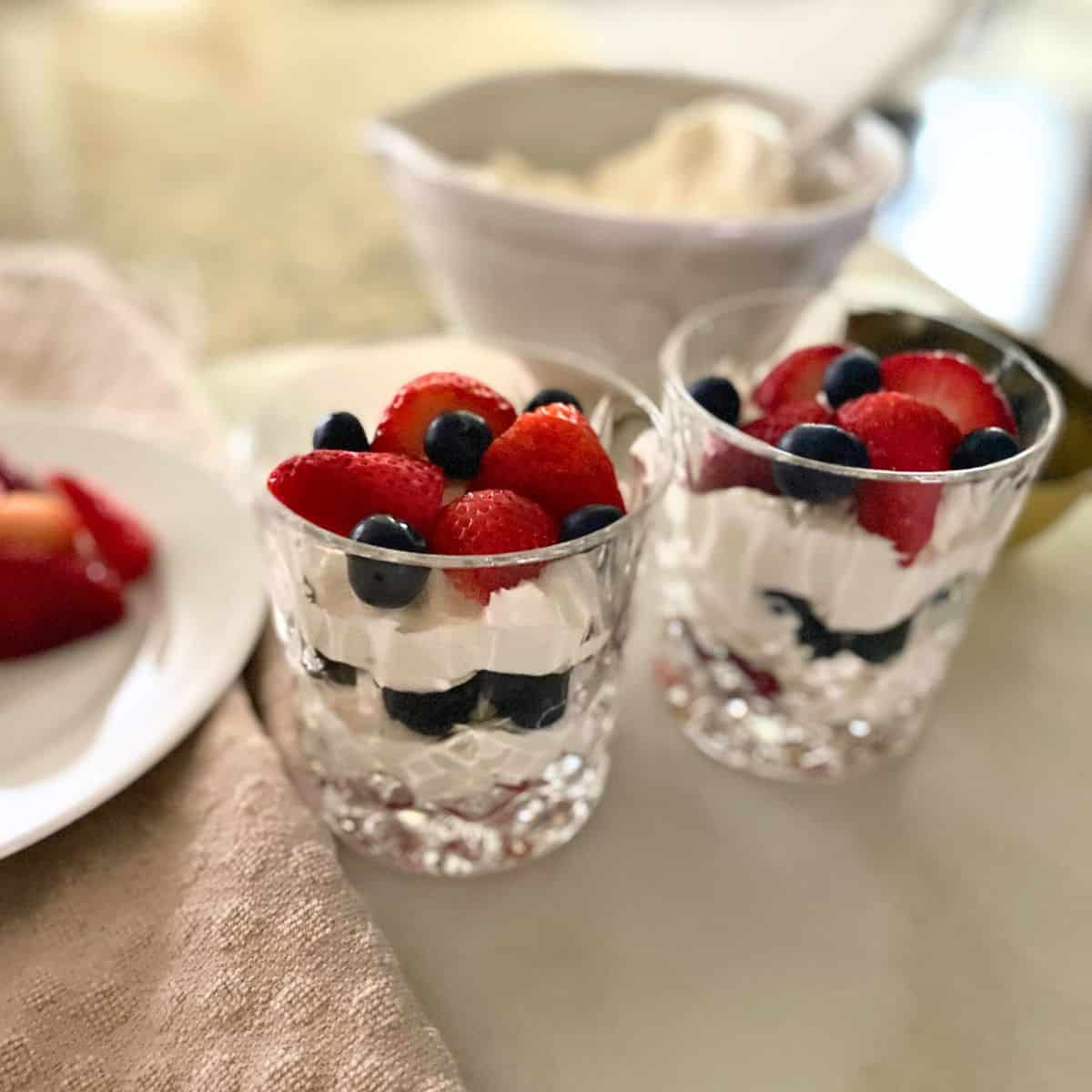 berries and cream in double old-fashioned glasses