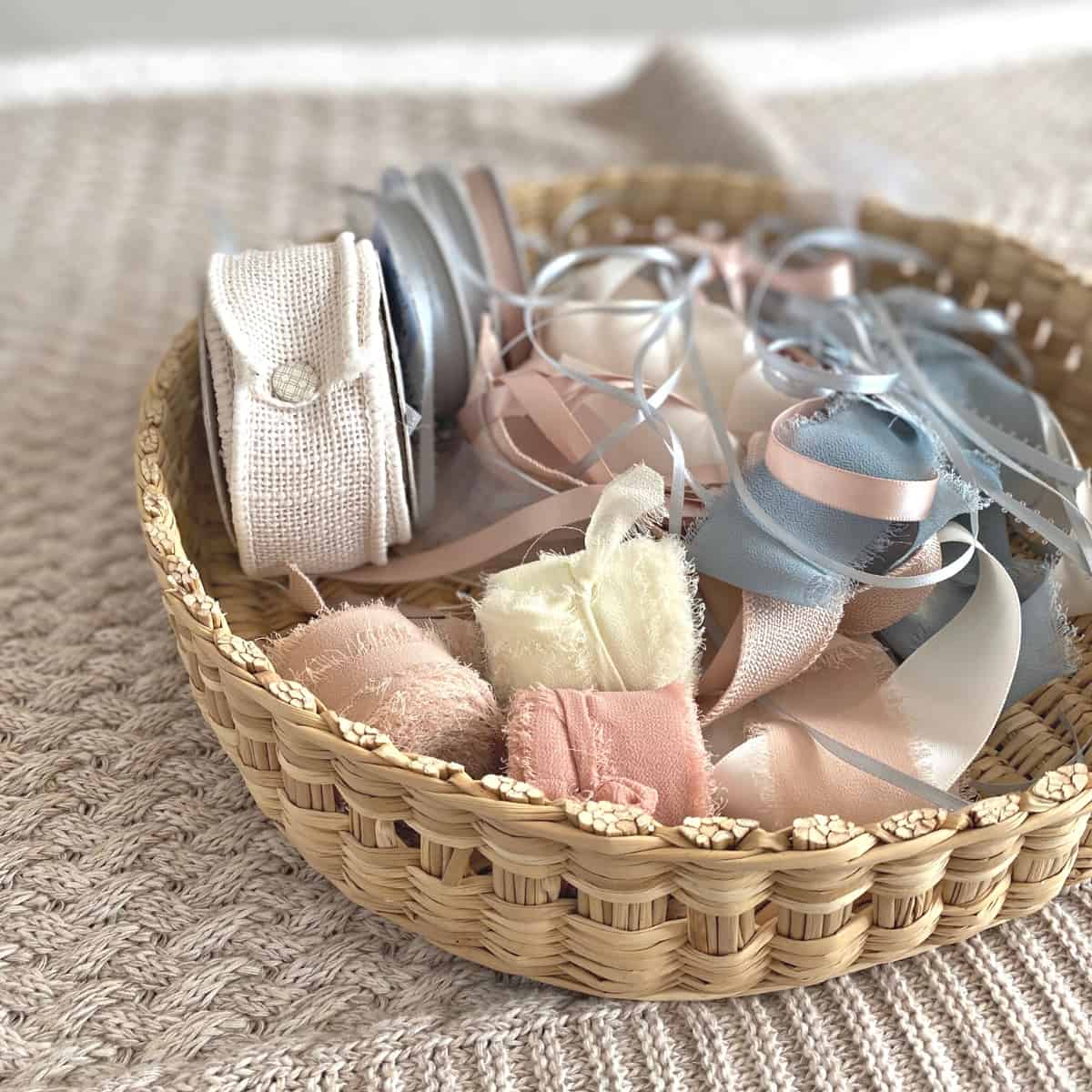 Rolls of ribbon and loose ribbon in a basket tray
