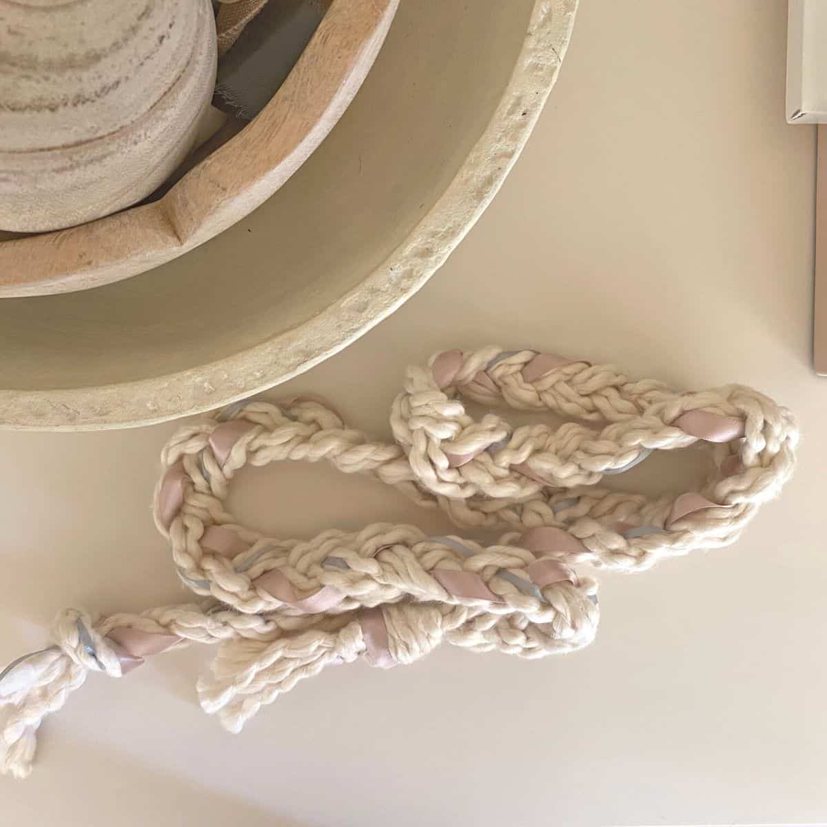 ribbon garland on top of a white dresser