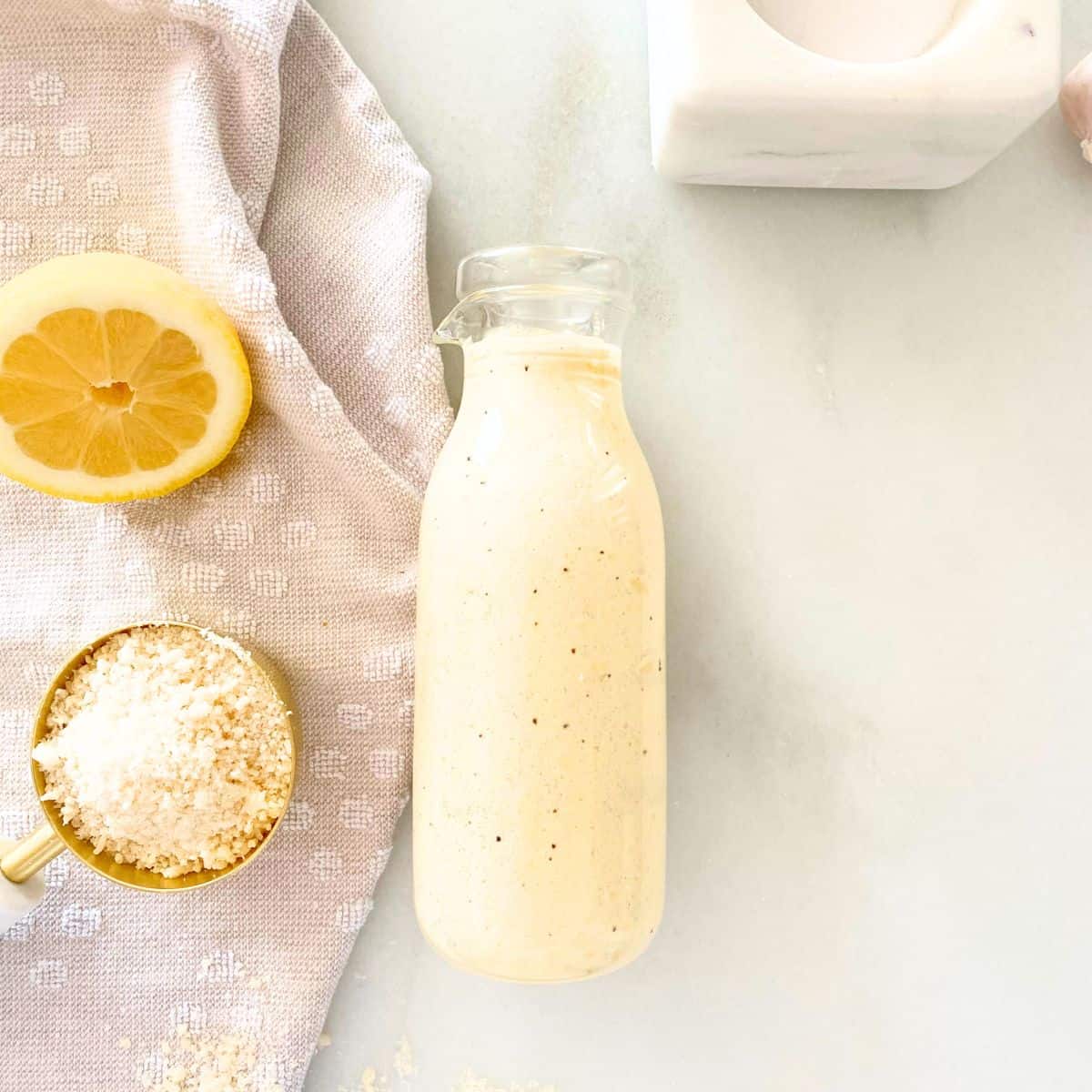 homemade Caesar salad dressing in a glass bottle