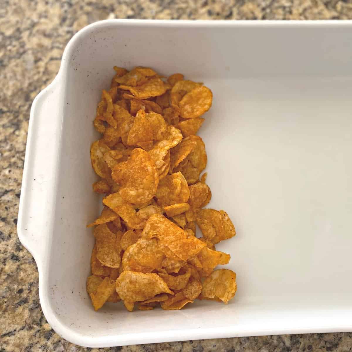 Potato chips served in one third of a white rectangular roasting pan