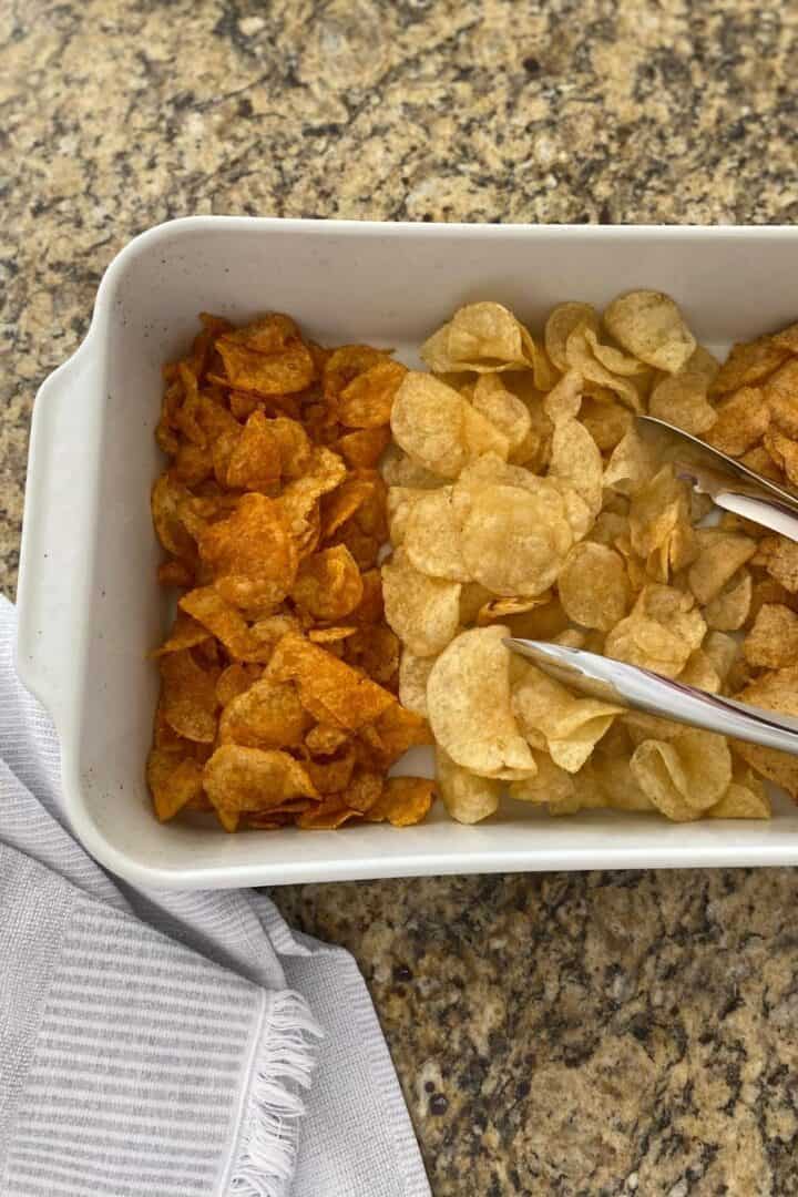 Assortment of potato chips neatly served in a white roasting pan