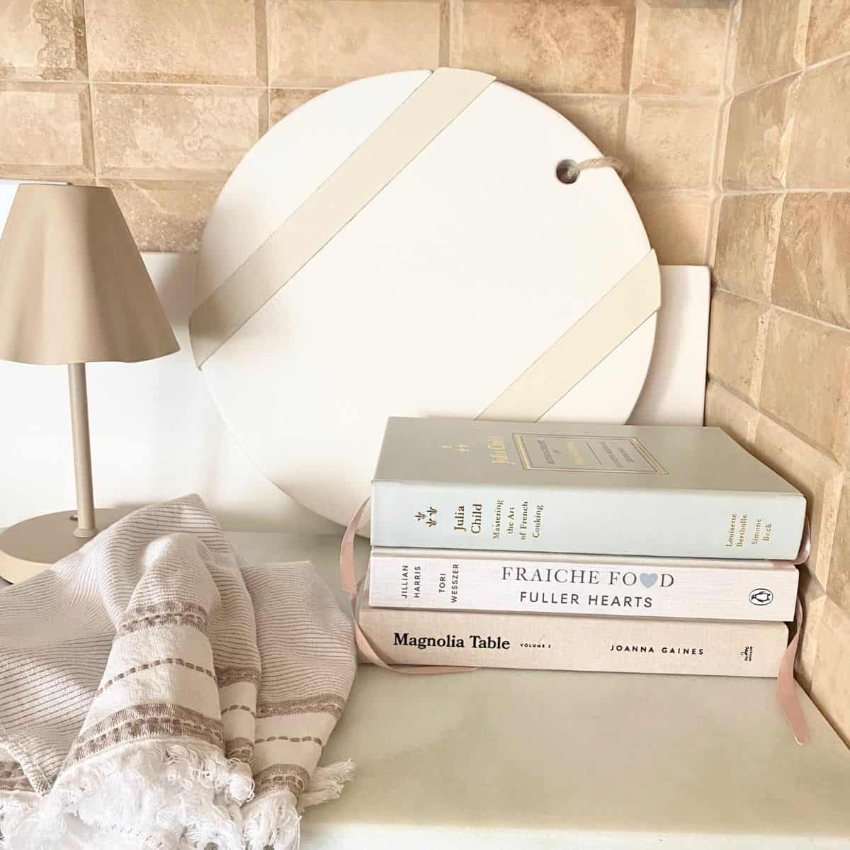 stacked cookbooks styled in kitchen