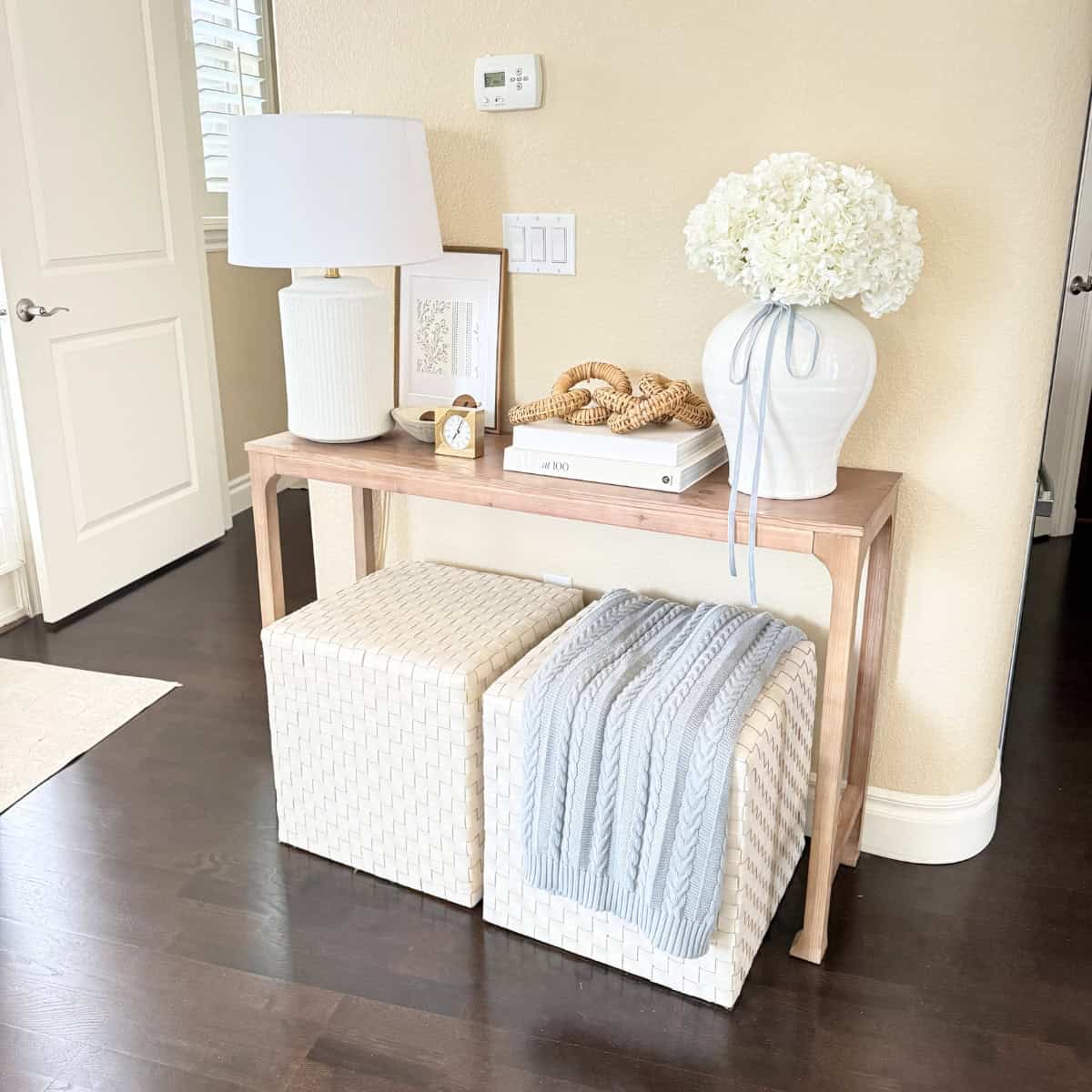 light wood entry table styled with decor