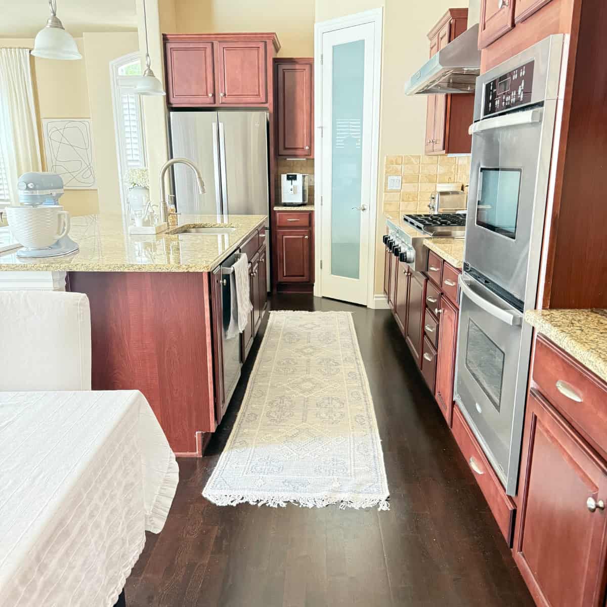 blue and cream kitchen runner between island and range