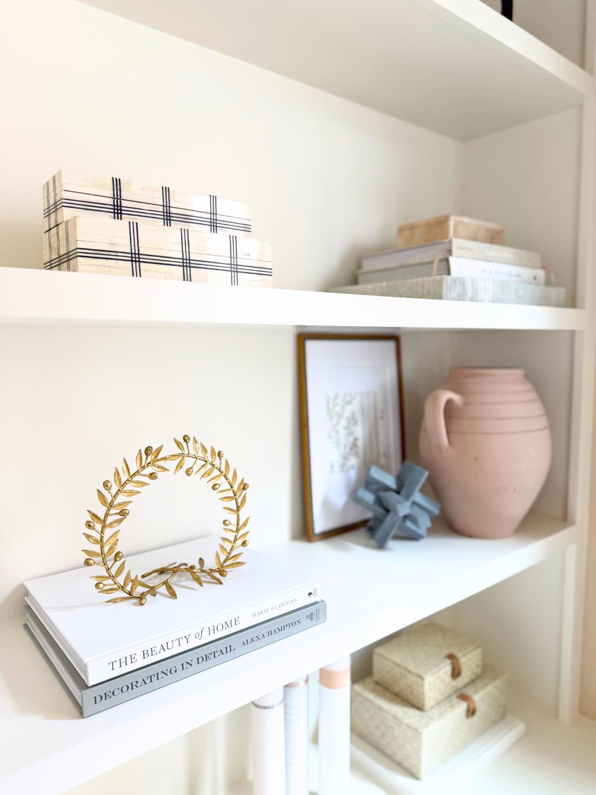 grid bone boxes and other decor styled on shelves