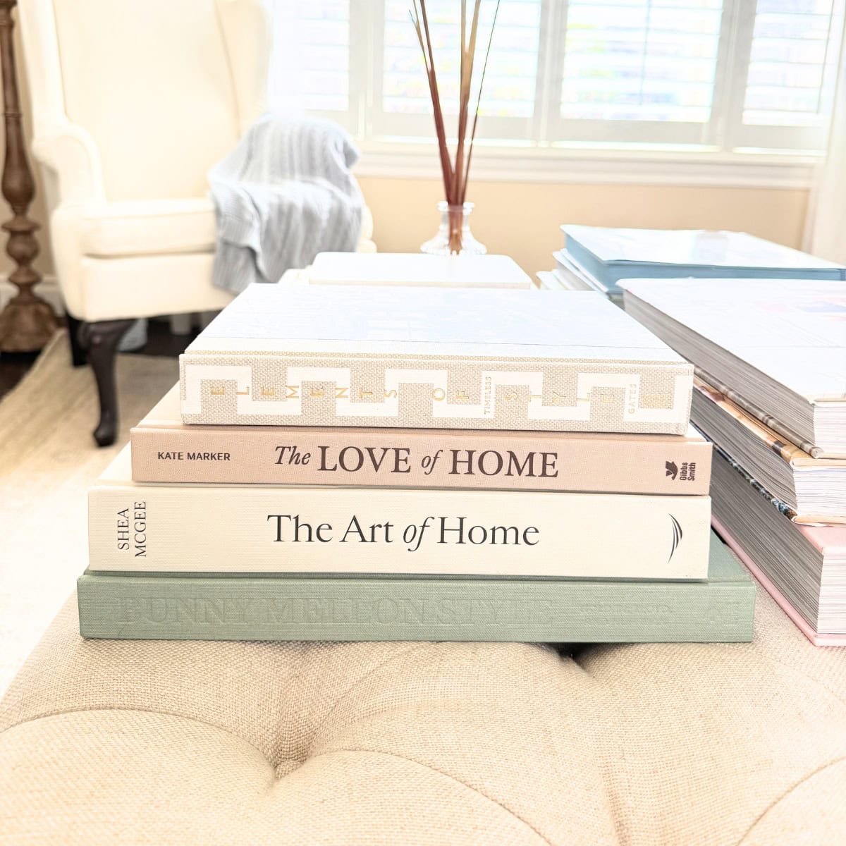 stack of interior design books on ottoman