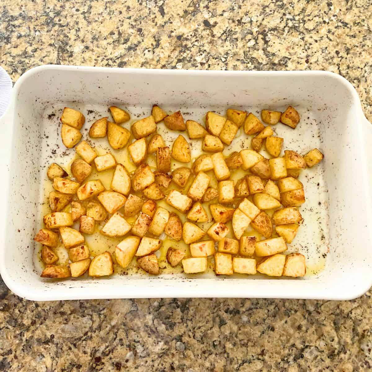 Partially baked home fries in a Pillivuyt porcelain rectangular roaster pan