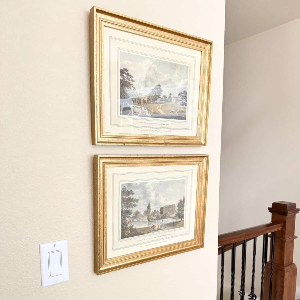 two vintage art prints hanging in a hallway